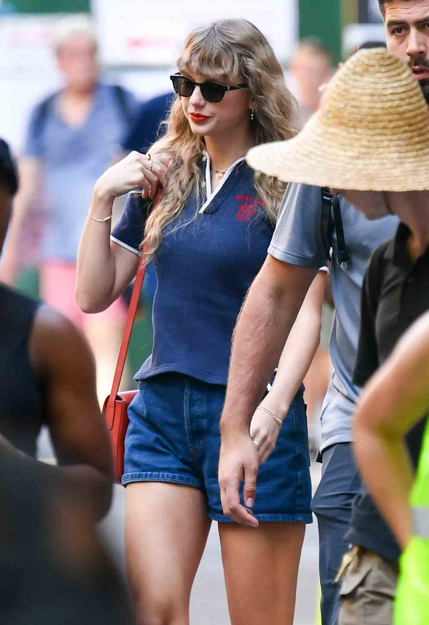 Taylor Swift wearing a preppy polo shirt and denim shorts
